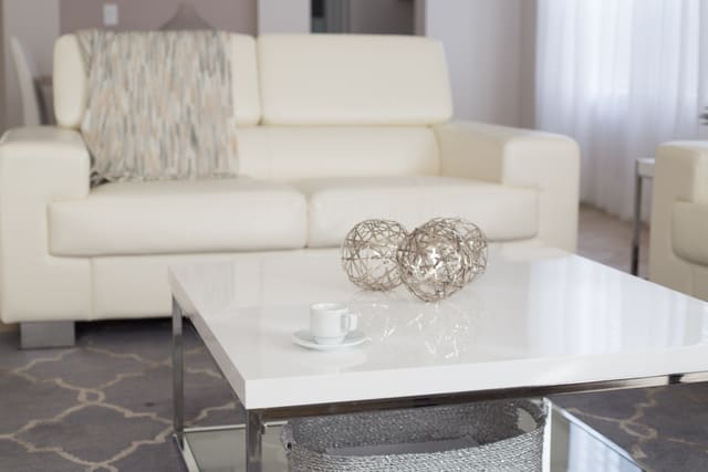 Tour preview thumbnail: living room with a white sofa and a glass-top coffee table.
